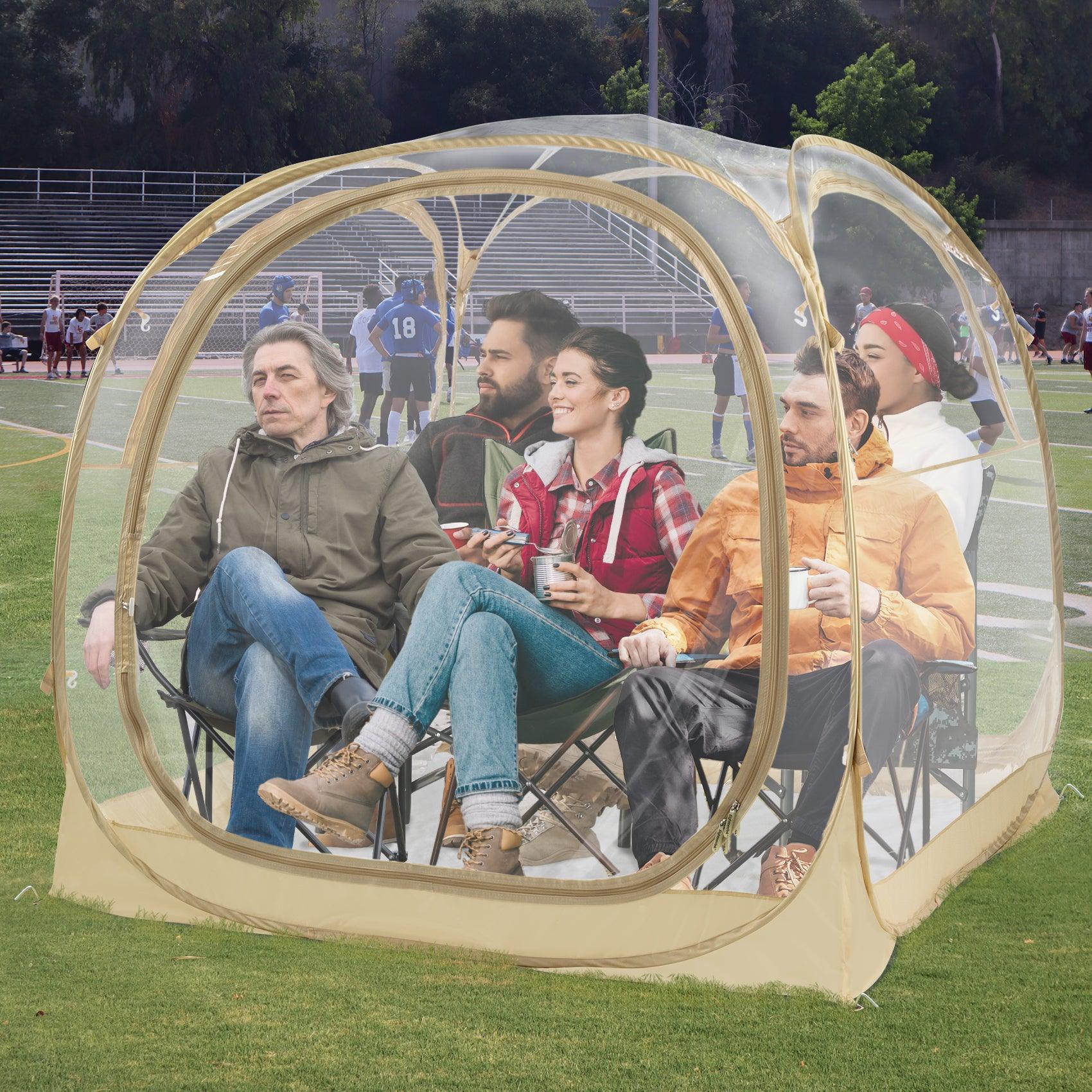 5 adults waiting on the sideline in a clear sports shelter