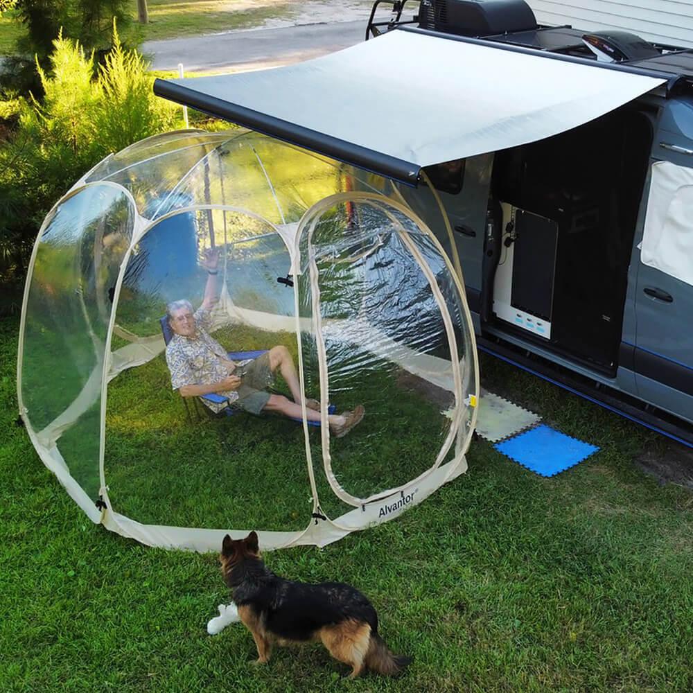 A man is taking a rest in a alvantor bubble tent during her RV trip.